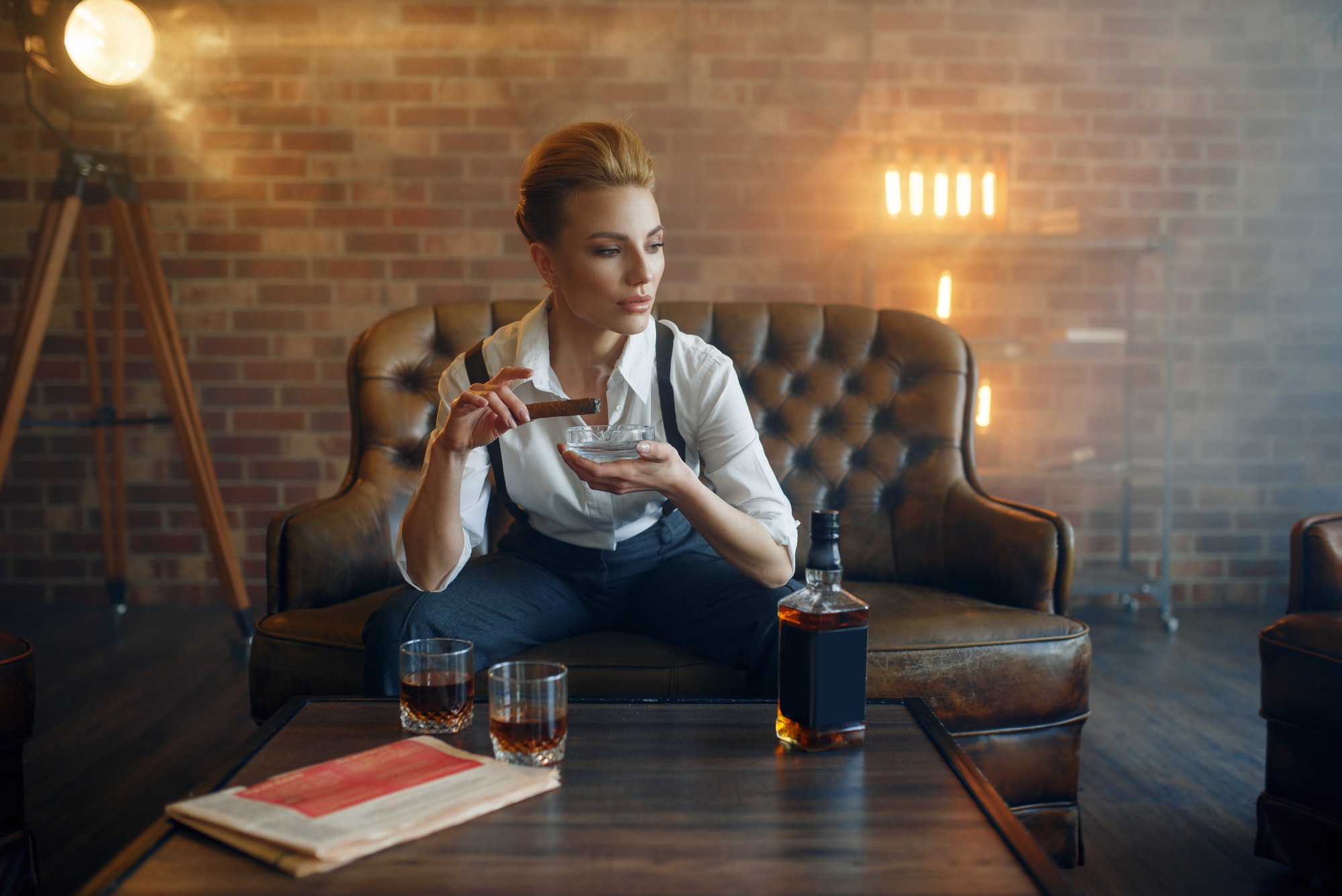 Woman in strict clothes smoking cigar, gangster